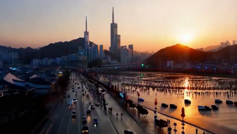 sunset over a city with a frozen river