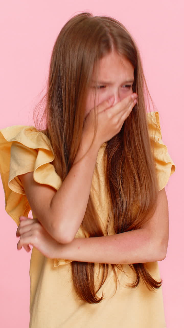 Child girl kid pretending to cry and lowering head with sad emotional expression in dramatic gesture