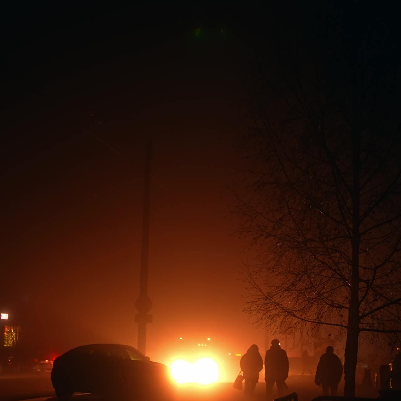 Bright soft light from a car spotlight illuminating the dark street during blackout. Ukrainian present-day lifestyle during power outages
