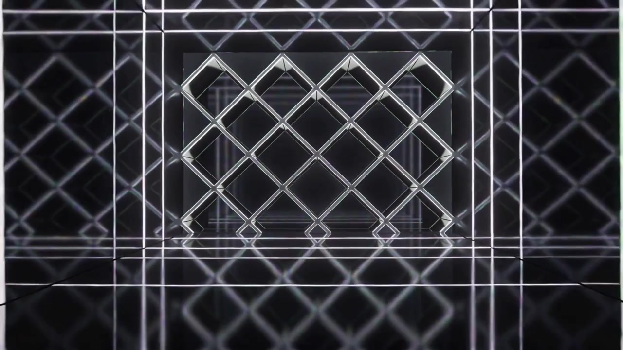 La telecamera si allontana rivelando una griglia di diamanti LED che si ritira in cornici in studio, creando un tunnel profondo.