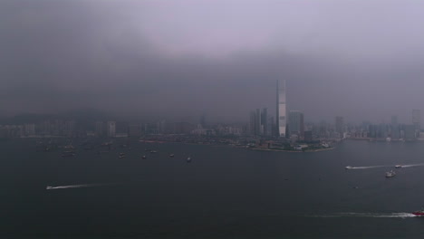 Wide-shot-of-heavy-thunderstorm-and-lightning-strike-near-ICC-Building-in-Hong-Kong-City---Aerial-flight