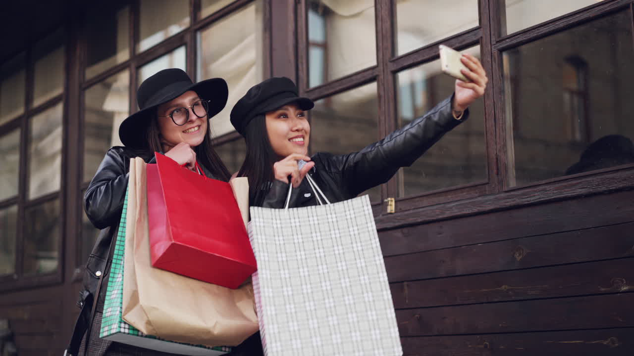 Two happy friends taking a selfie after shopping