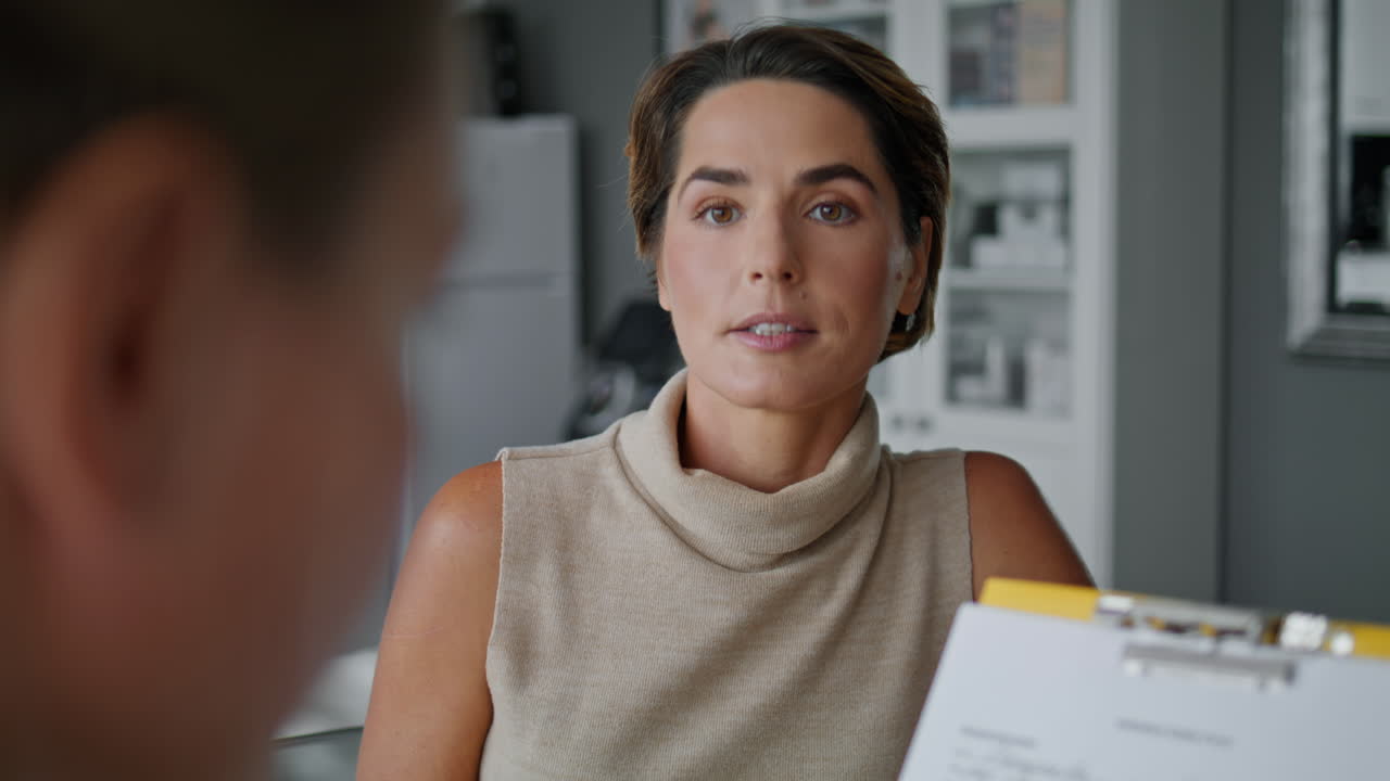 cosmetóloga hablando con una mujer paciente antes de los procedimientos de cosmetología cerrar.