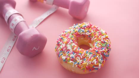 pink dumbbells and a donut