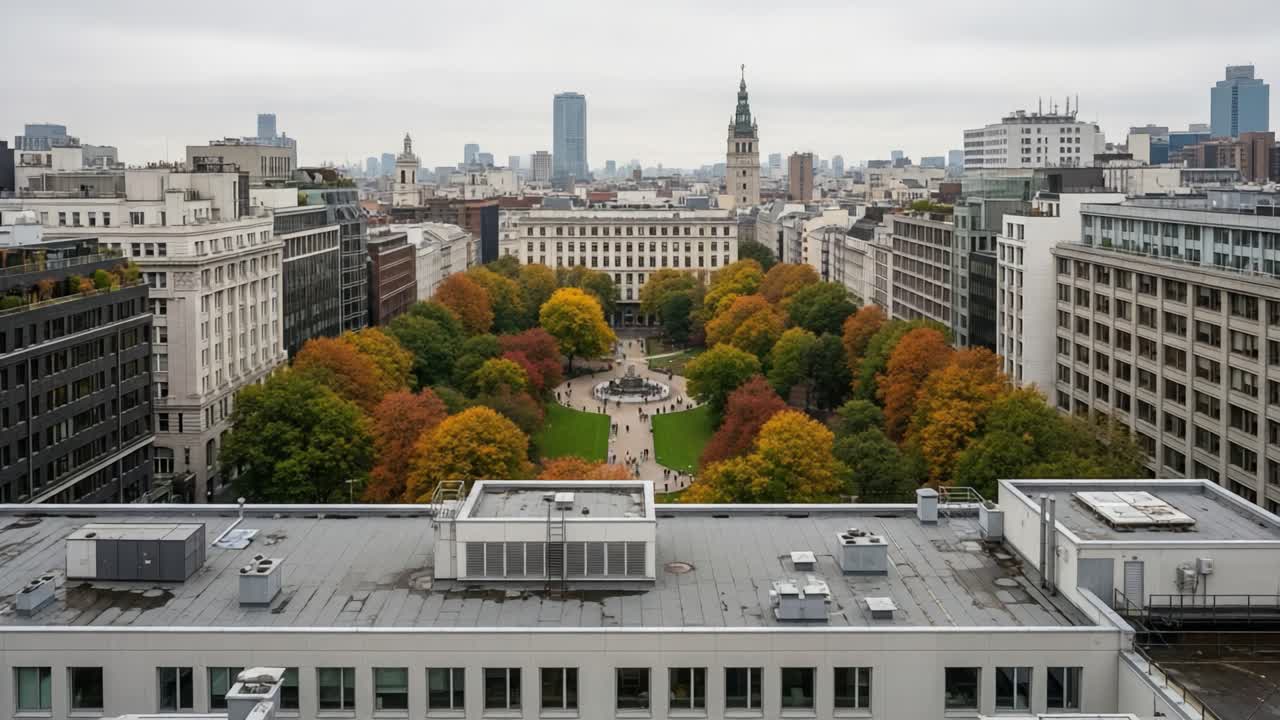 Aerial View of Urban Park Surrounded by Vibrant Fall Foliage and Cityscape, Showcasing Flourishing Greenery Amid Modern Architecture and Cloudy Skies