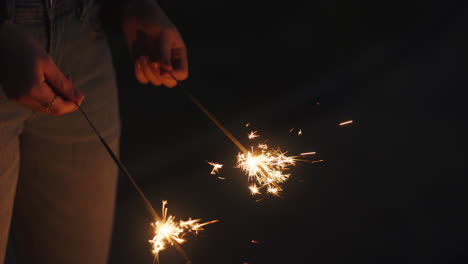 woman holding sparklers celebrating new years eve at sunset enjoying independence day celebration 4th of july