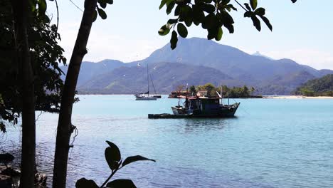 old wooden fishing boat with birds flying around