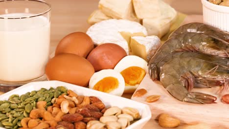 variety of protein foods displayed on wooden surface