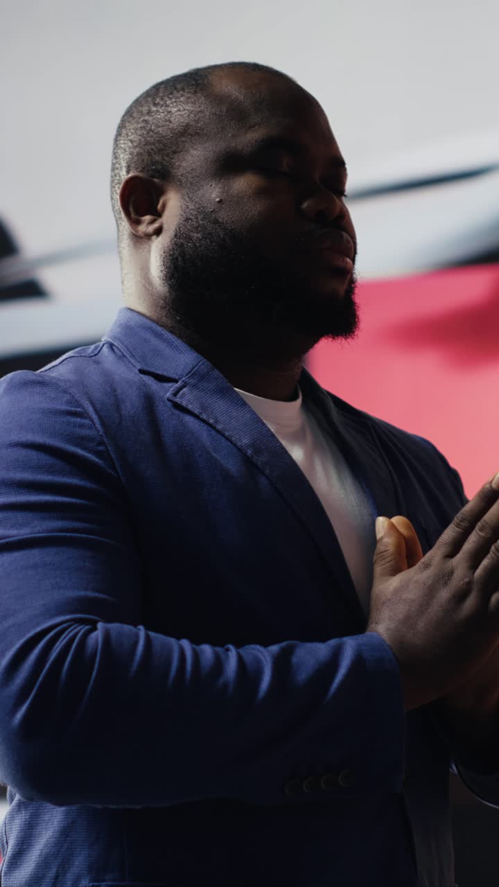 African American Man Meditating with Hands Together in Prayer