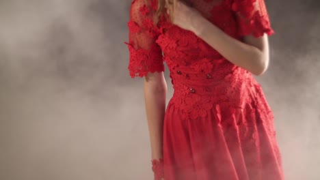 beautiful woman over smoky background. beautiful woman in red dress over smoky background