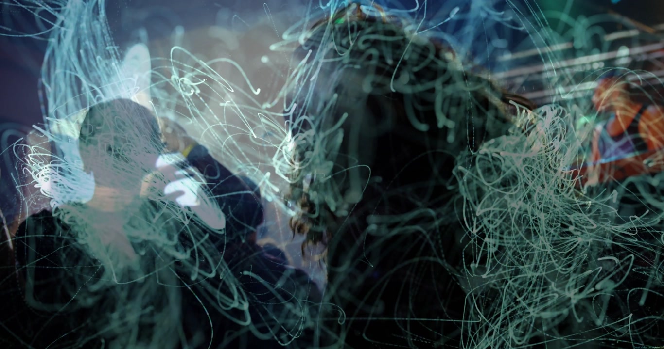 Two in front raising arms, moving to music as performers starting set, teal light trails overlaying