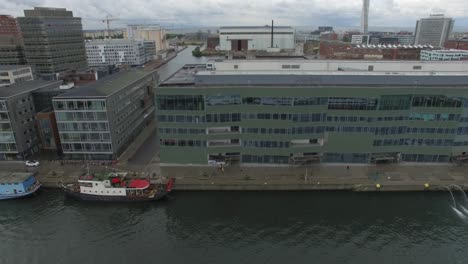 drone shot of office buildings along canal in malmö city, sweden