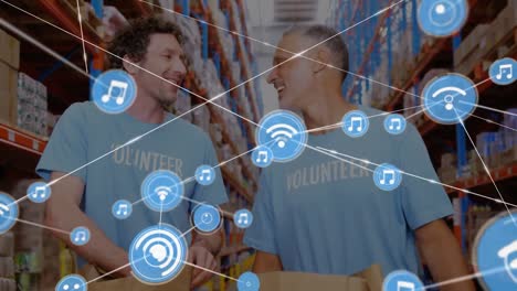 Animation-of-network-of-connections-with-icons-over-diverse-people-in-warehouse