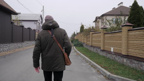 man walking down a suburban street