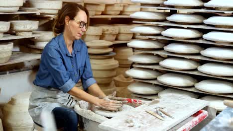 female potter molding a clay 4k