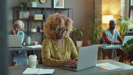 african american businesswoman working on laptop in office