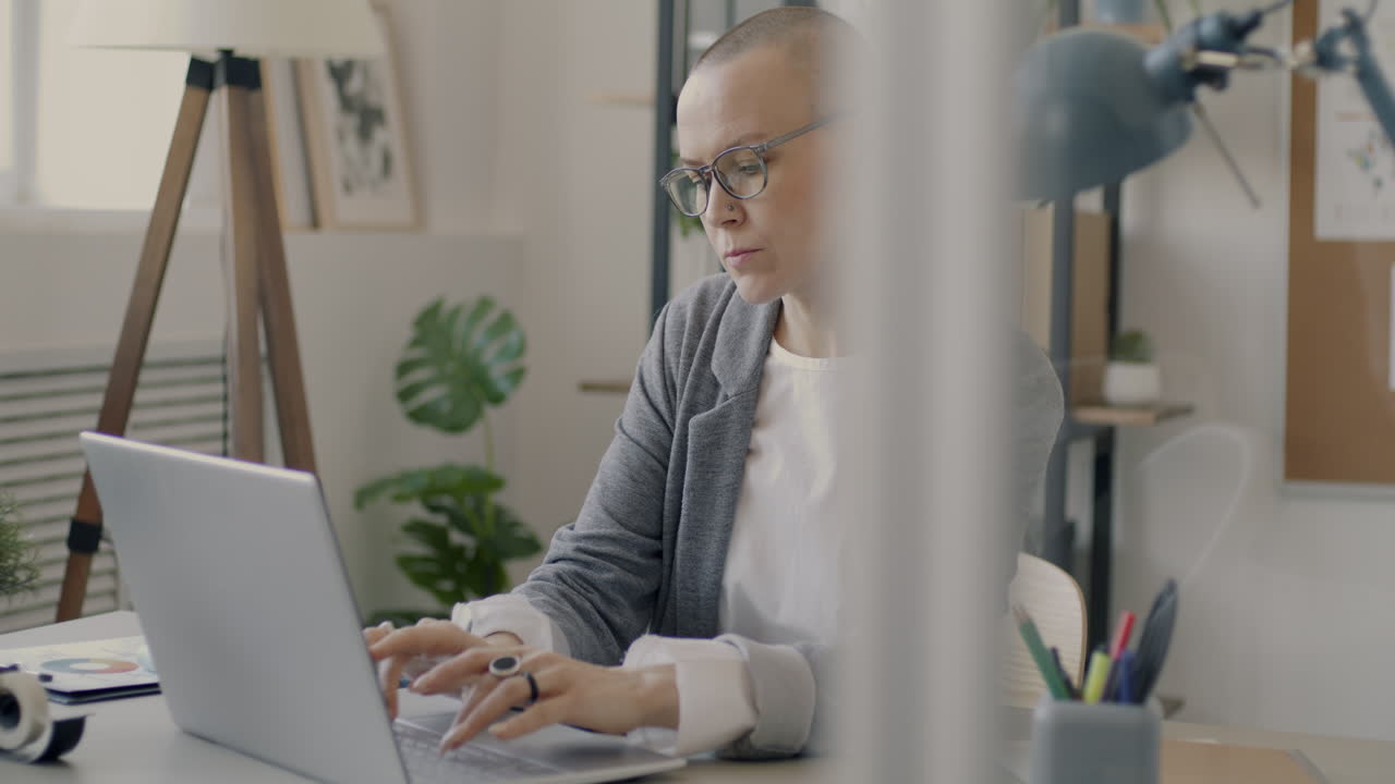 Woman Working on Laptop in Modern Office