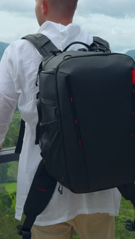 man wearing a camera backpack