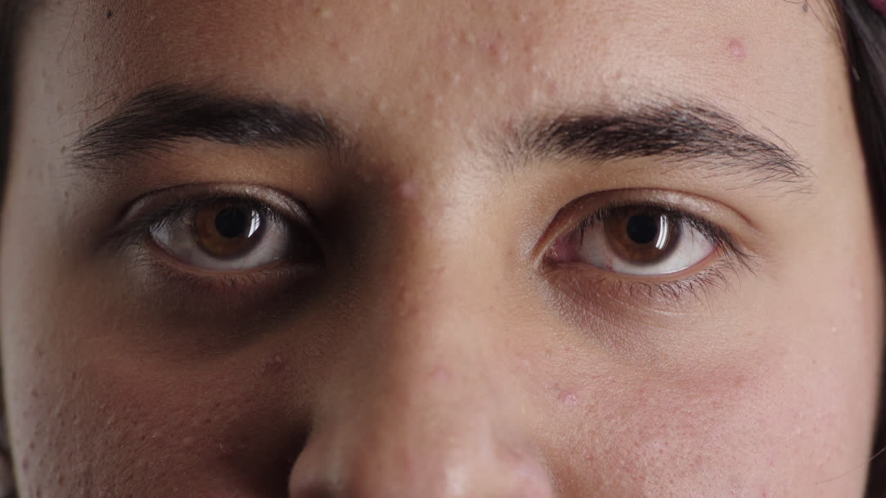 가까운 십대 남자의 눈은 카메라를 바라보고 심각한 사려 깊은 표정