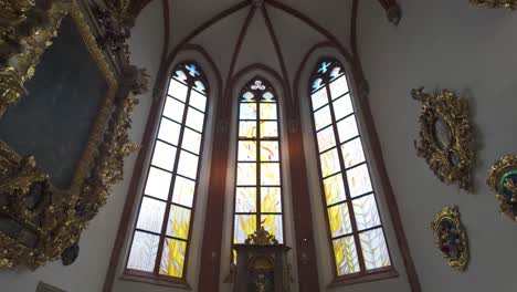 ornate church chapel interior with stained glass windows