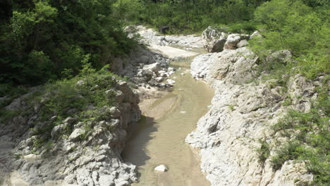 caribbean mountain river of nizao during summer in dominican republic - aerial pullback