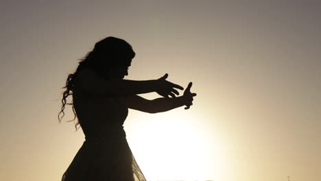 Silhouette-of-girl-dancing-in-sunset