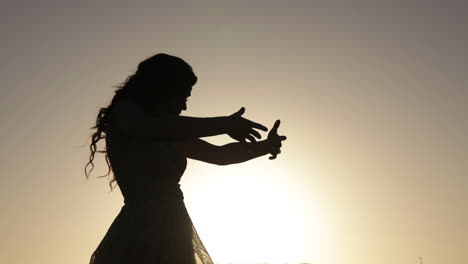 silhouette of girl dancing in sunset