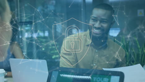 animation of padlock in shield and connected dots over diverse coworkers discussing on desk