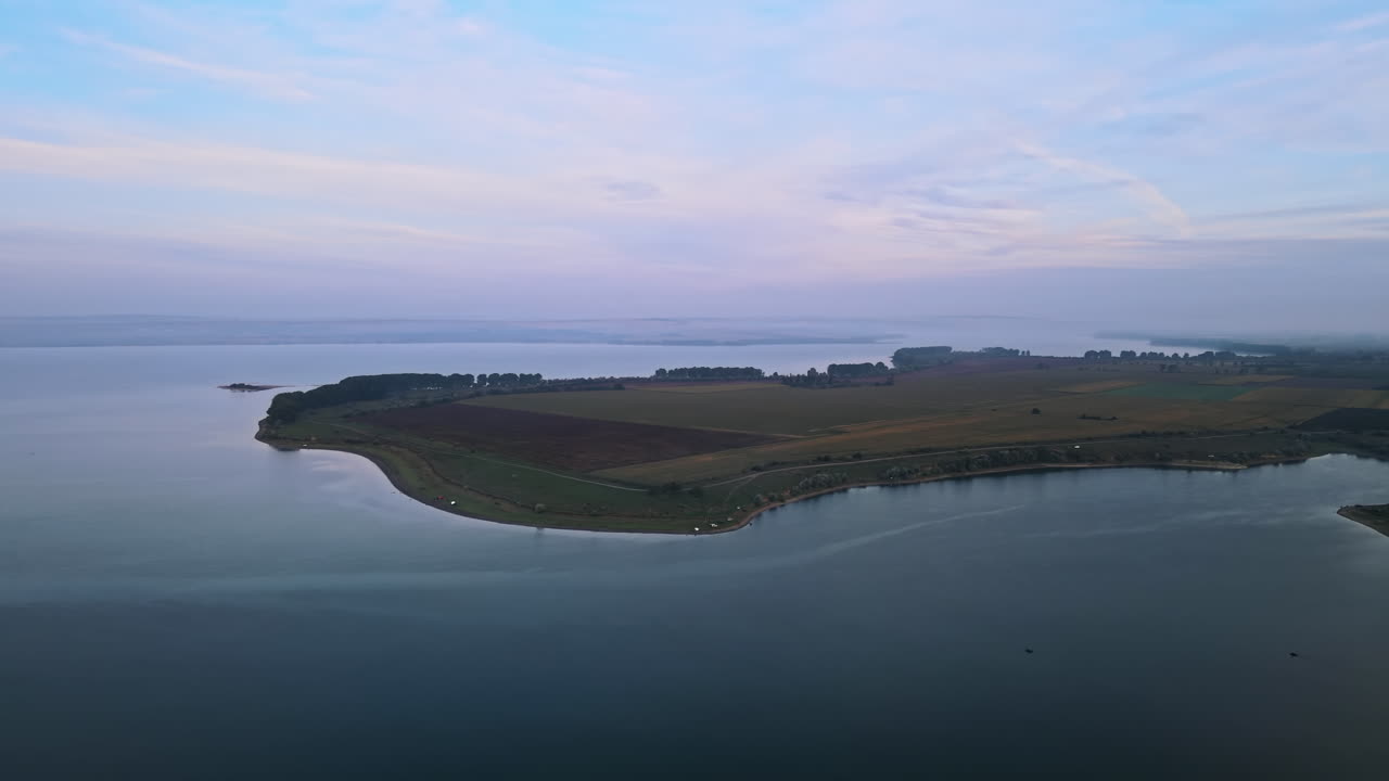 Aerial drone view of the Duruitoarea natural reservation in Moldova. River and fog in the air, fields