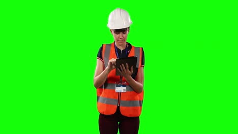 front view of a site forewoman using digital tablet with green screen