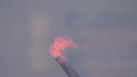 close-up of a burning signal flare held by a man in 4k slow motion 60fps