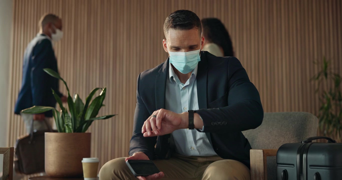 Businessman Wearing Face Mask Waiting in Airport Lounge
