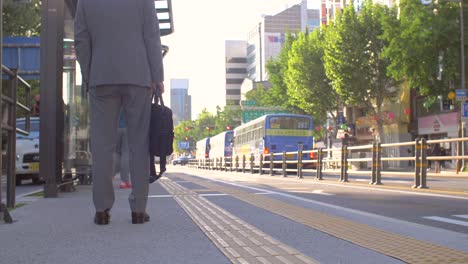 smart commuter waiting at bus stop