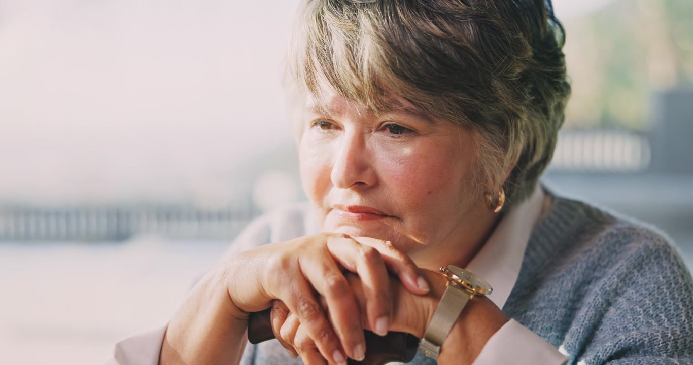 Thoughtful Senior Woman Resting Hands on Walking Cane