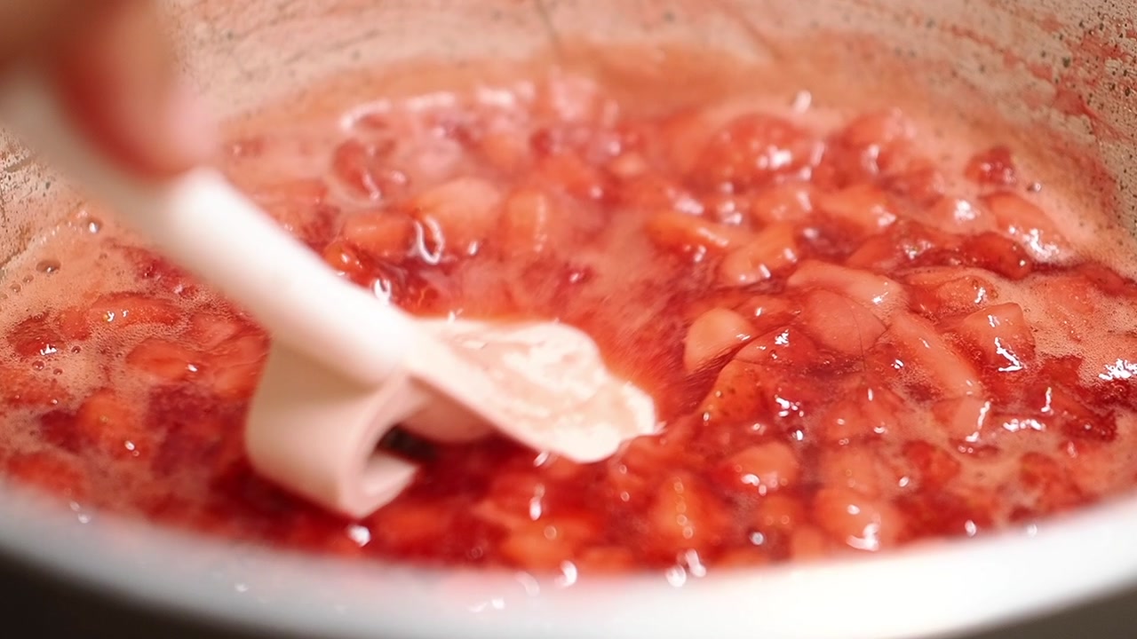Close-up of Strawberries Cooking and Mashing in a Pot for Jam