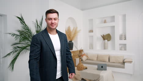dark-haired caucasian male in jacket looks at his smartphone. portrait of a confident entrepreneur working remote.