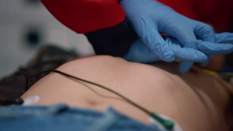 ambulance doctor hands providing patient cardiac massage on stretchers