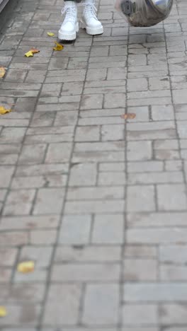 person cleaning up trash on a sidewalk