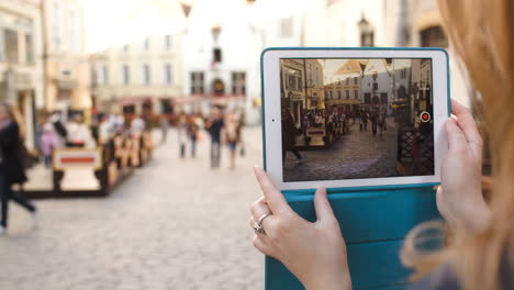 Frau-Mit-Tablet-Macht-Video-Von-Der-Straße-In-Tallin-Und-Schaut-Es-Sich-Dann-An