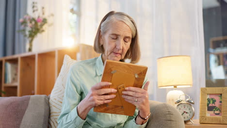 elderly woman looking at a photo frame