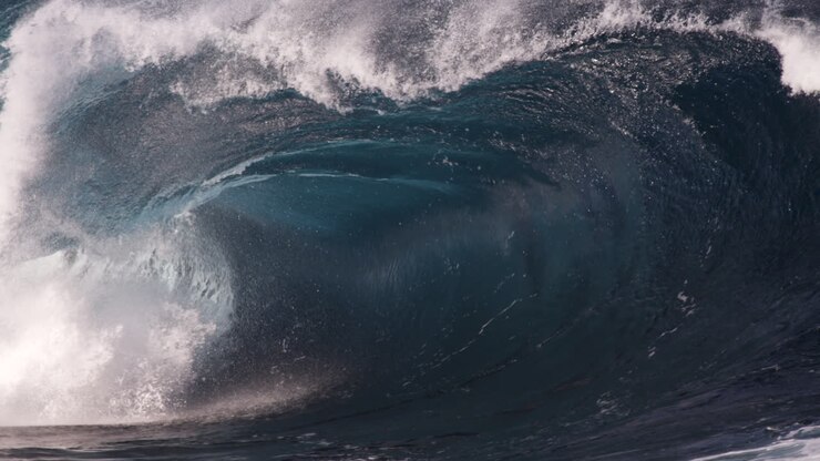 A close look at the inside of a heavy wave as it breaks along a shallow rock shelf in slow motion