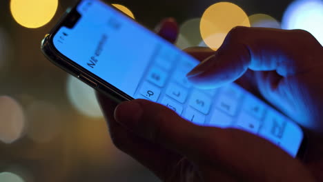 person interacting with a smartphone at night
