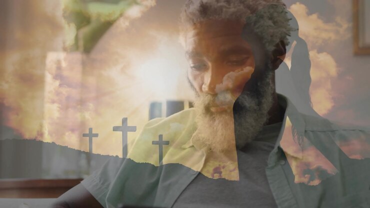 Bearded man leaning reading devotional then tapping smartphone with sunrise cross overlay lingering
