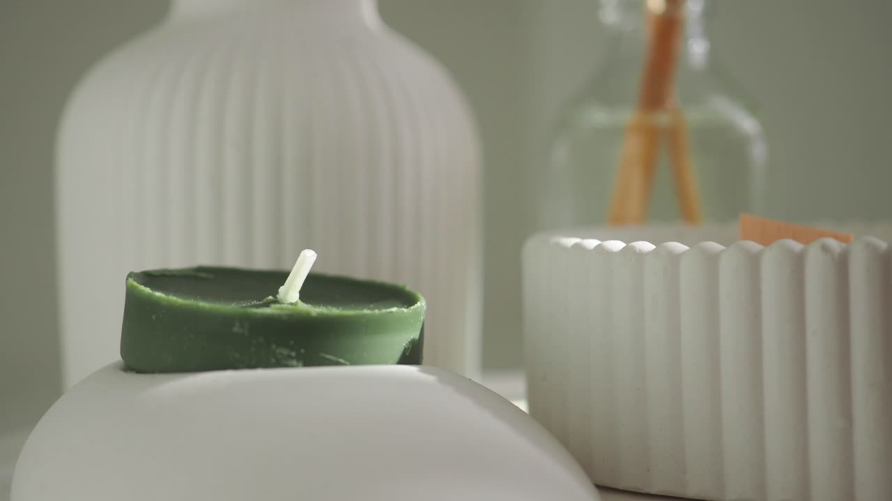 Green candle with white decor