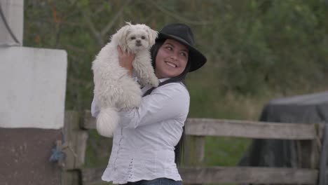 Beautiful-lady-holding-her-cute-small-white-dog