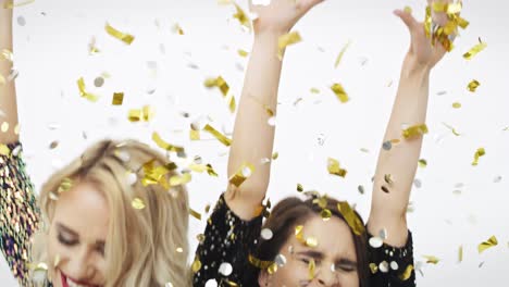 two women dancing among falling confetti