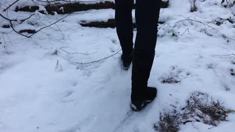 Closeup-of-woman-climbing-up-snowy-stairs-in-a-mountain-during-winter