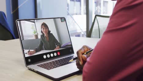 Animation-of-african-american-man-having-video-call-on-laptop