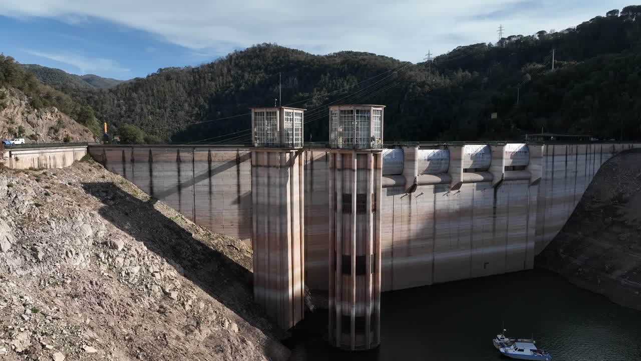Low water level dam during drought season in Spain, aerial ascend view