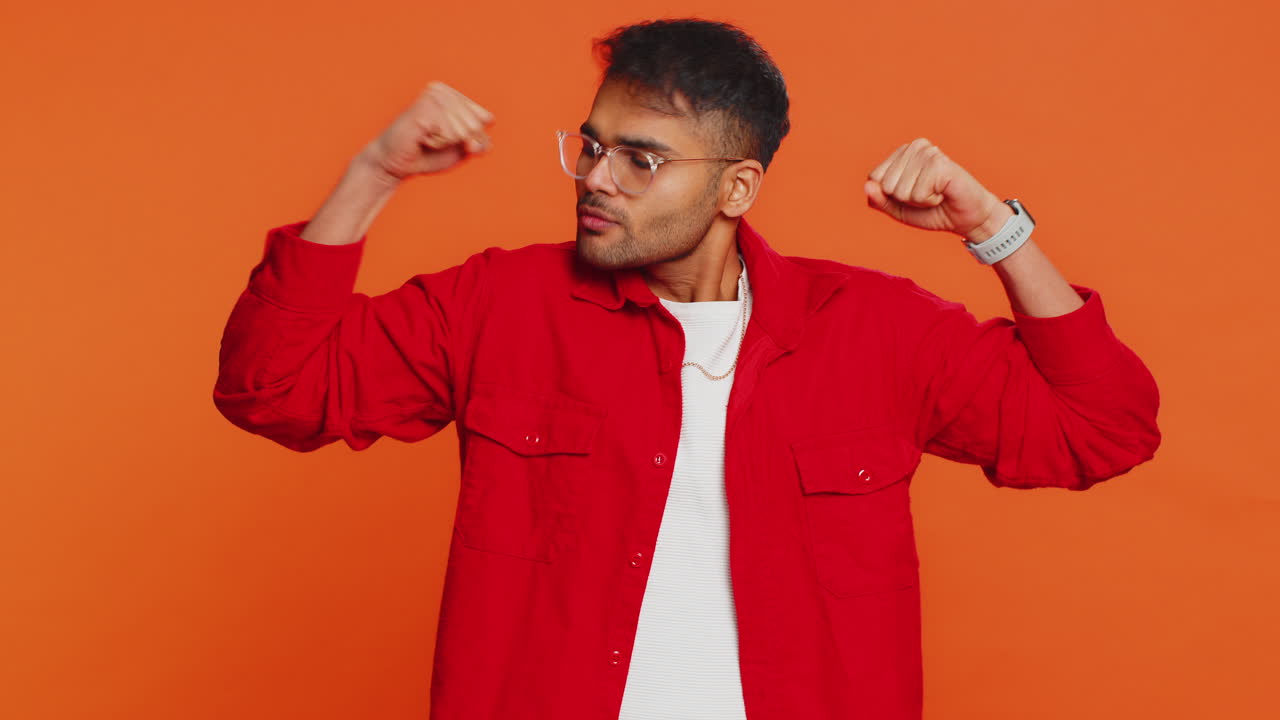 Man looking confident showing biceps feeling power strength to fight for rights success win